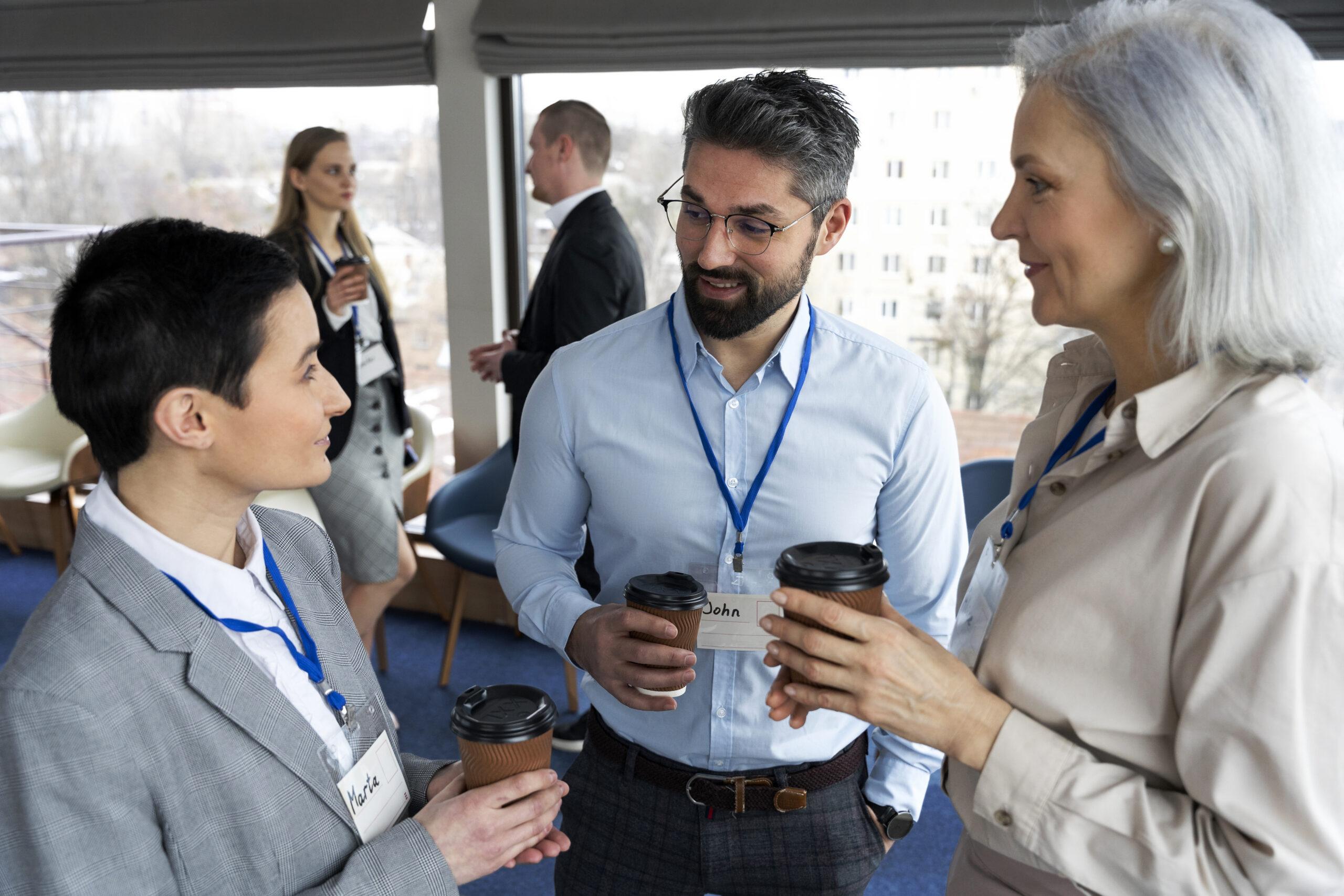 Professionals networking and discussing during a corporate event, showcasing effective corporate event management strategies.