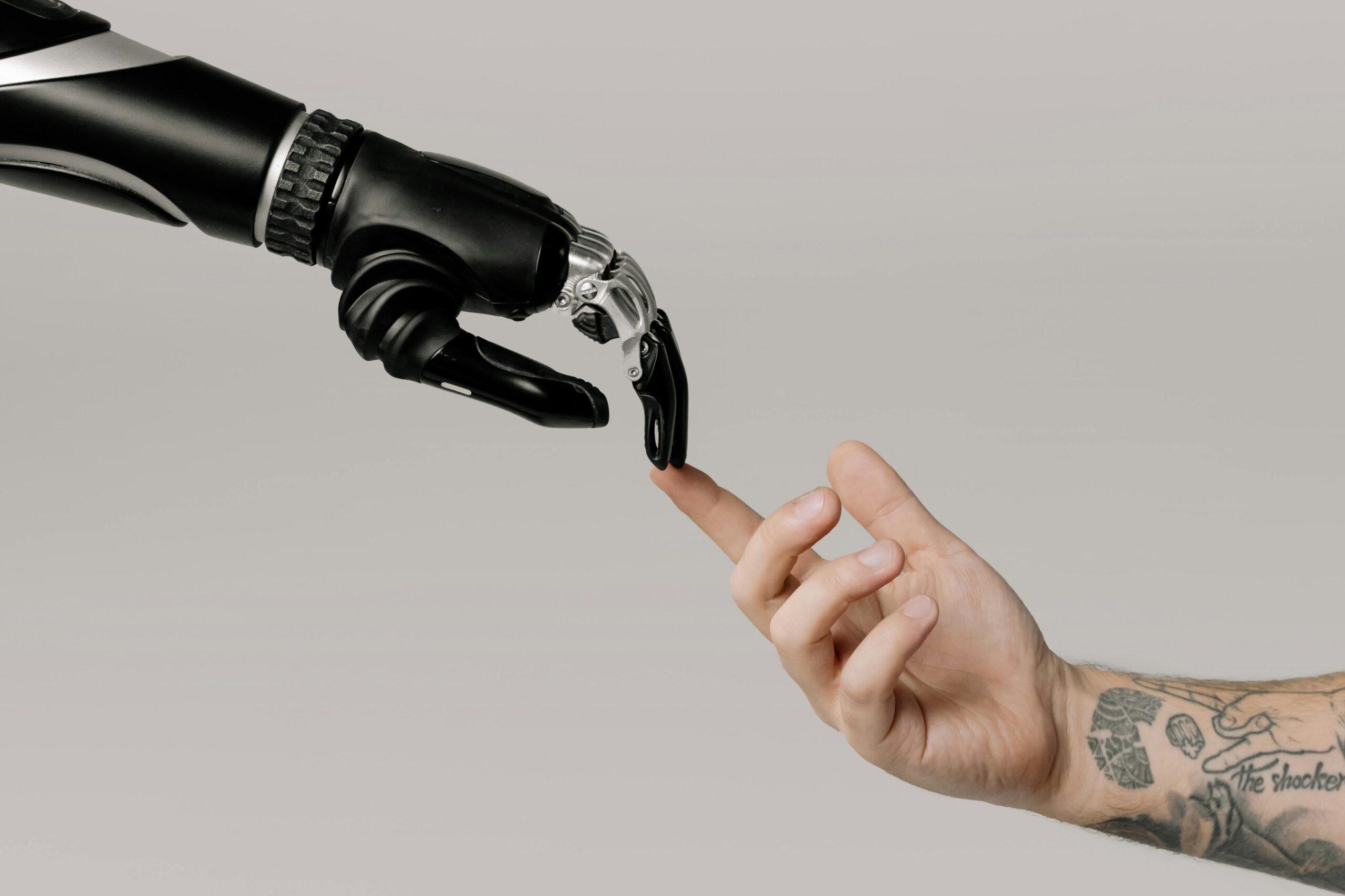 A robotic hand and a human hand reaching out to touch, symbolizing the integration of AI in recruitment and HR outsourcing processes for streamlined collaboration.