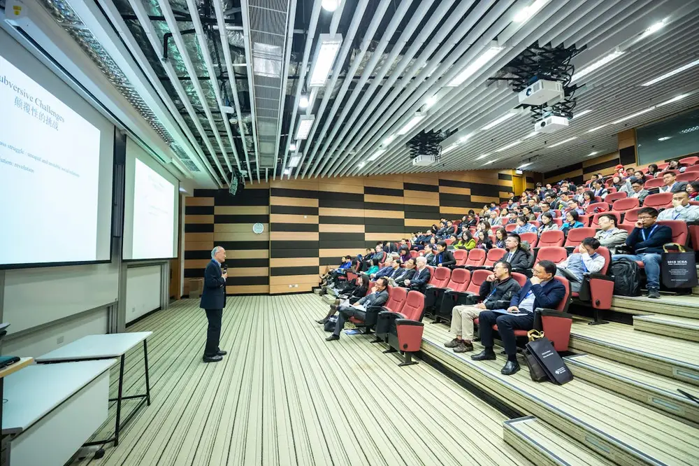 Man standing in front of people during Corporate Event Management.