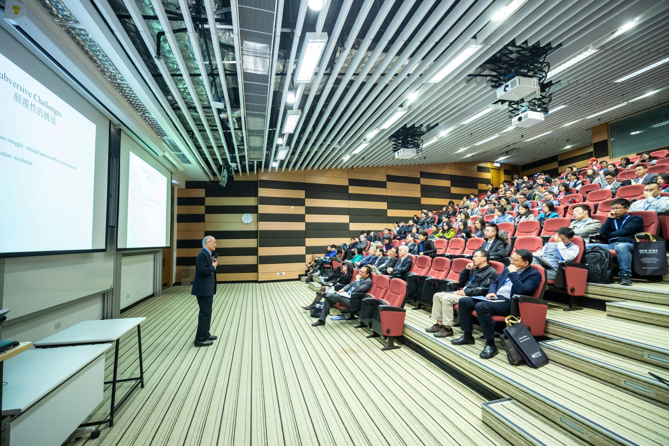 Man standing in front of people during Corporate Event Management.