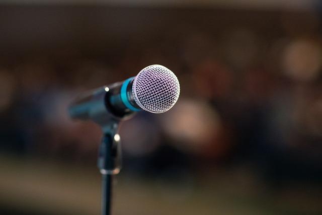 Close-up of a microphone used for public speaking on a stage.