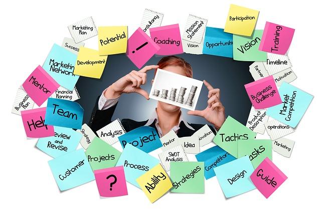 Person holding a smartphone is surrounded by colorful sticky notes with event planning terms.